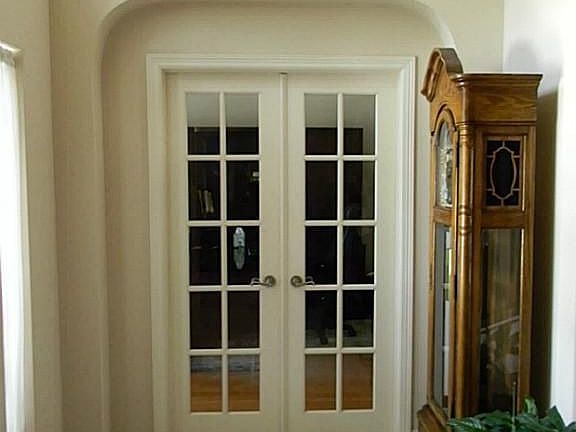 Immediately to the left is the formal living/study behind French doors.