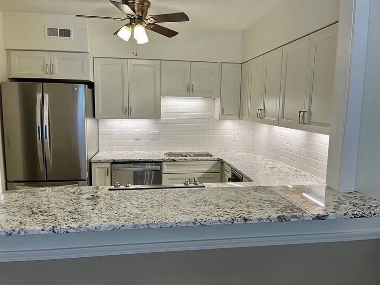 updated kitchen features newer appliances, cabinetry and granite countertops