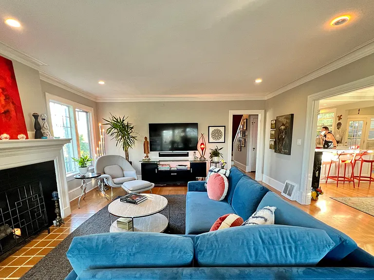 Another view of living room showing access into the kitchen and dinning room through the French doors.