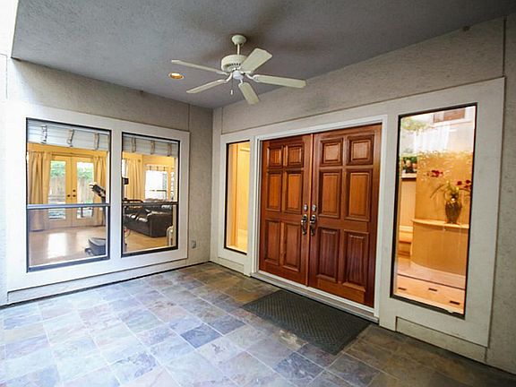 Private covered patio and entry is secured behind a gated entryway.