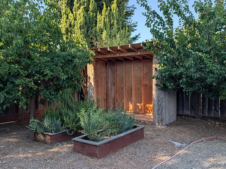 Gardening beds with a potting shed / tool storage.