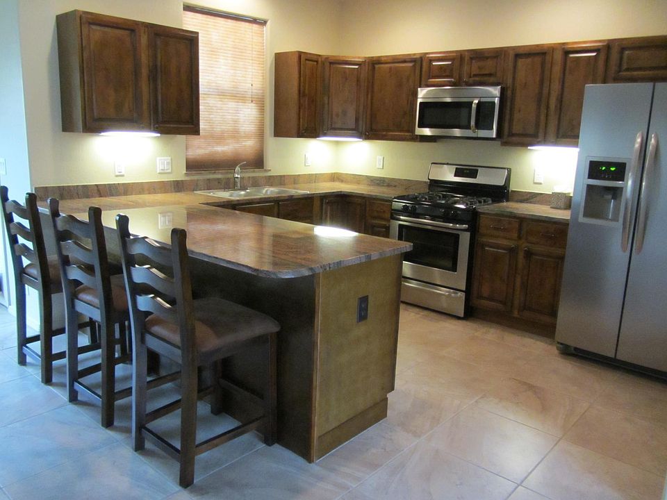 Kitchen with granite counters and s/s appliances.