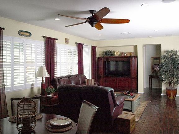 Comfy living room w/ plantation shutters and fireplace (not shown)