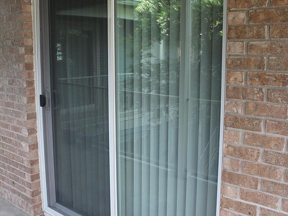 A large sliding door provides courtyard views from the living room.
