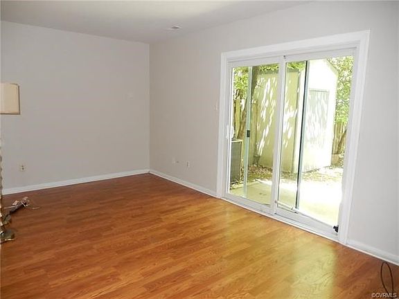 Living Room w/ Hardwood laminate floors and slider to fenced in back yard.