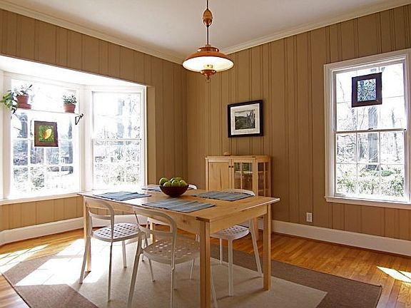 Formal Dinning Room Features A Bay Window And Built-In Cabinet