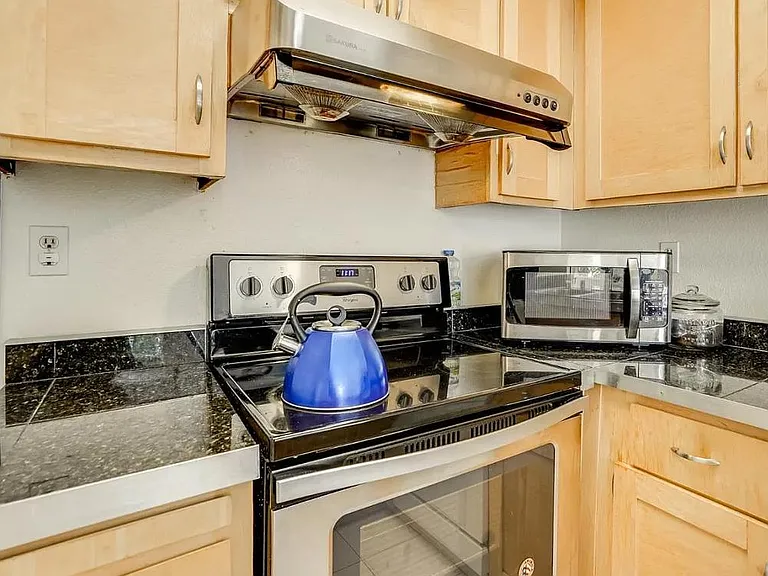 Lovely Modern Kitchen , Fully Equipped with New Stainless Steel Appliances, Granite Counters, Modern Pass-Thru Window Bar to the Spacious Dining room.