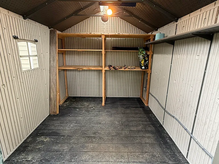 The inside of an exterior shed (10'x12') in the backyard. Has lights and outlets (to keep battery powered items charged).
