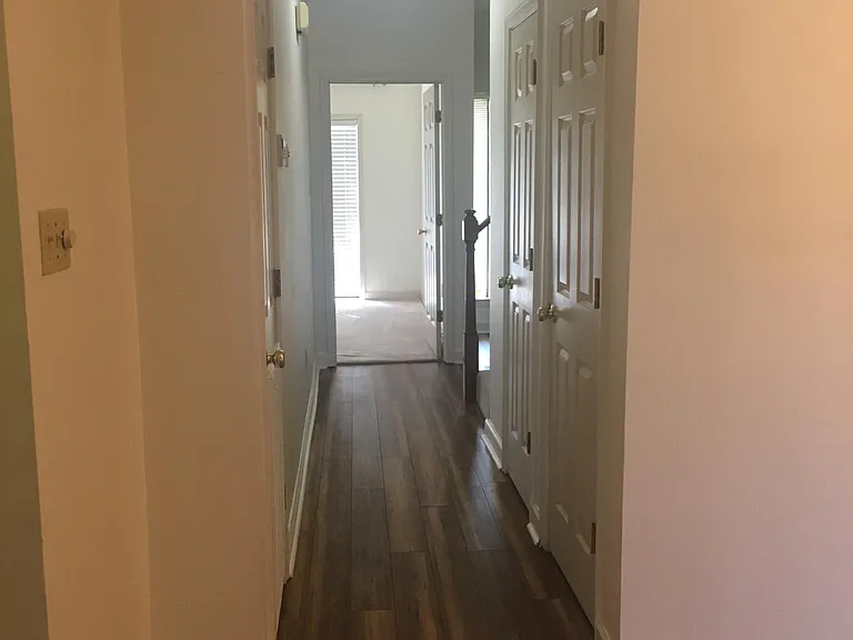 From the living room and breakfast room, going down the hall to Primary bedroom.