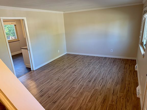 Living room view from the staircase (front door to the right, kitchen pocket door to the left) will have curtains installed prior to move-in