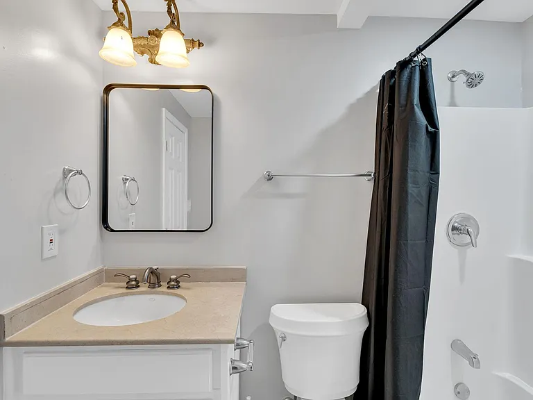 Modern full bathroom featuring a sleek vanity, clean toilet, and stylish tub/toilet combo for your comfort and convenience!