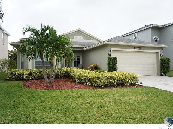 Freshly painted exterior with new leaded glass front door, tropical landscaping and a fire hydrant a few feet away which reduces your homeowner's insurance premium.