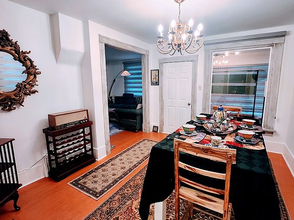 View of dining room table from hallway looking onto the door of the enclosed porch