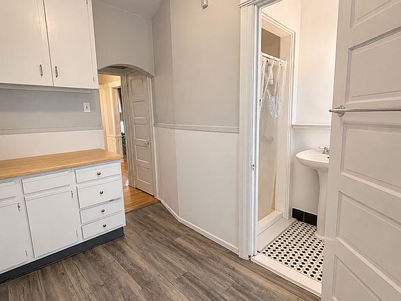Kitchen, standing at back door. Bathroom on the right. Notice two closet in hall as you exit kitchen back toward front door.