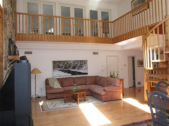 Wood floors are easy to keep clean!! The closed door behind the couch leads to the garage. Beside that door is a half bath.
