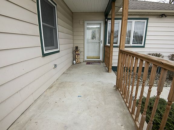 Nice covered front porch to enjoy the view of the professionally landscaped front yard.