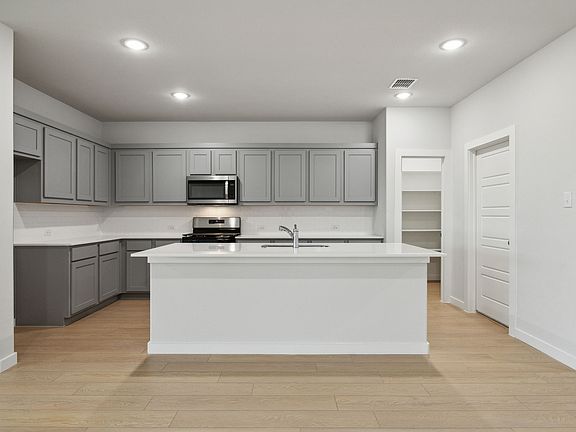 Kitchen in the Oscar home plan by Trophy Signature Homes - REPRESENTATIVE PHOTO