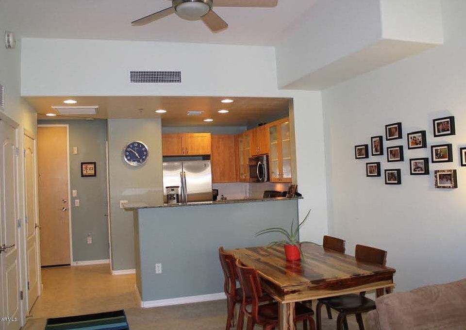 View of dining area and kitchen (from living room area as furnished by prior resident)