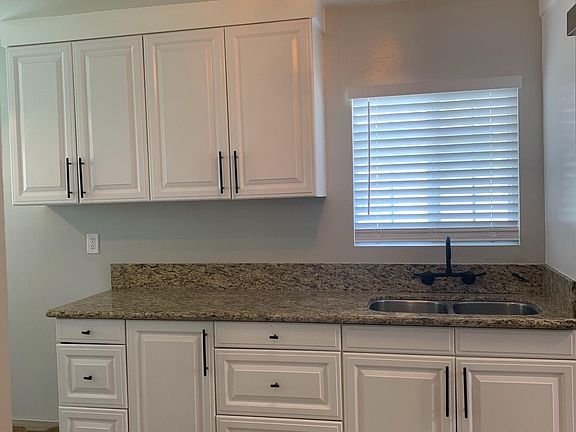 Refurbished cabinets, with modern hardware and granite counter.