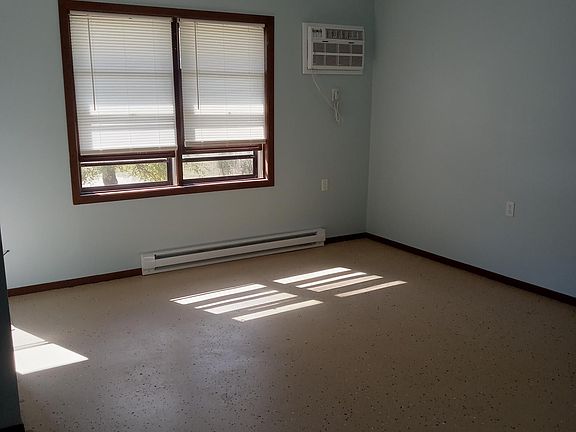 Living room with new window air-conditioner and updated efficiency electric heating throughout.