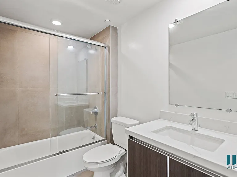Bathroom with Shower Bath with Glass Door and Vanity Cabinet Storage