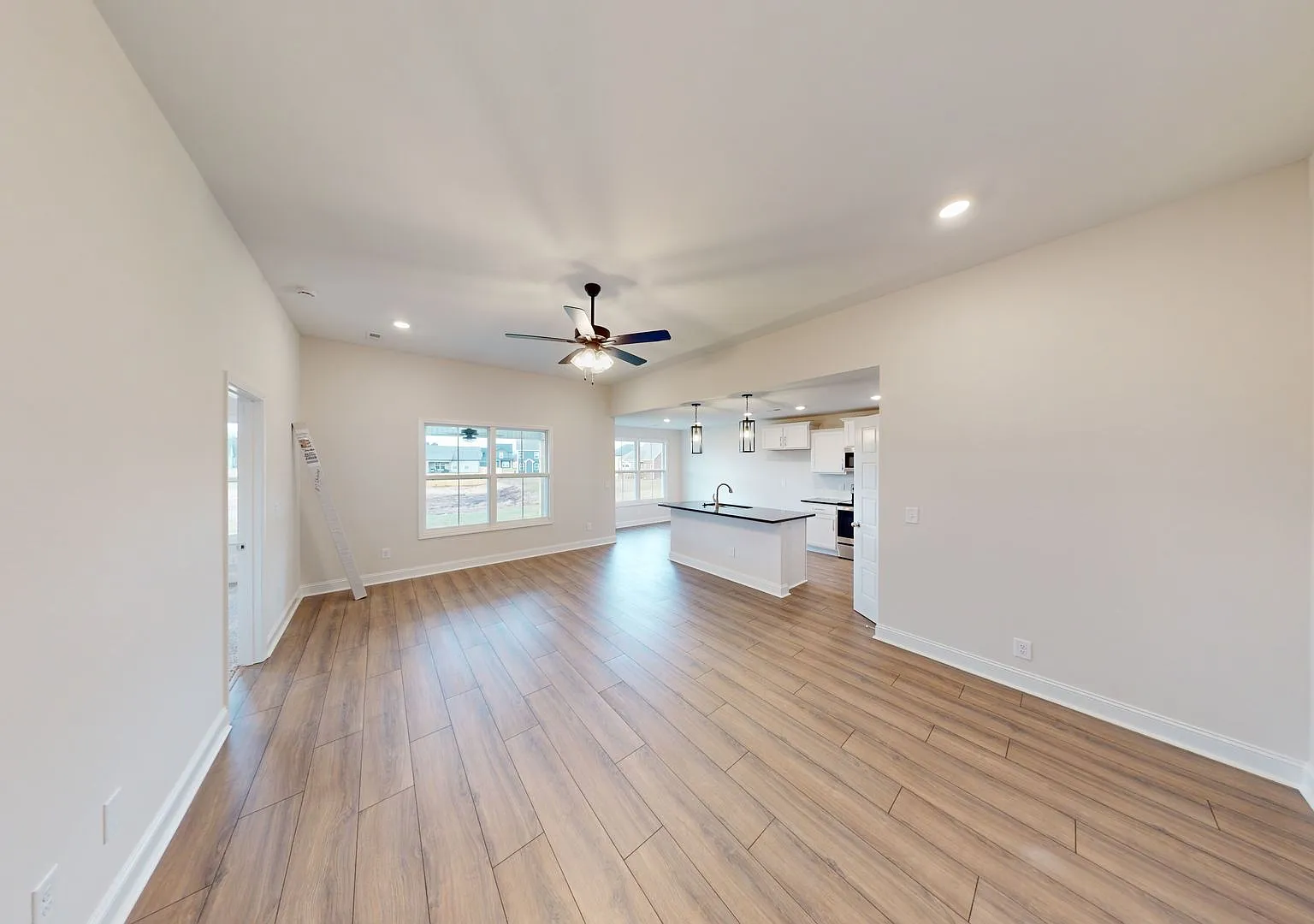 Open-Concept Home with Modern Upgrades Featuring Hardwood Flooring and Open Kitchen — Photo 3