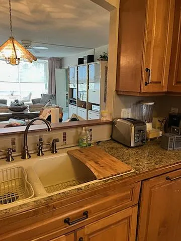 view from kitchen through condo. Custom panel on newly installed high-level Bosch dishwasher. Because it's so quite, a light shines to let you know it is running.