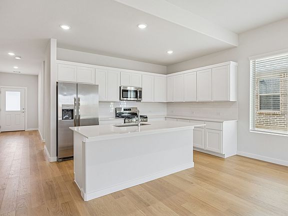 Kitchen in the Stanley II home plan by Trophy Signature Homes - REPRESENTATIVE PHOTO