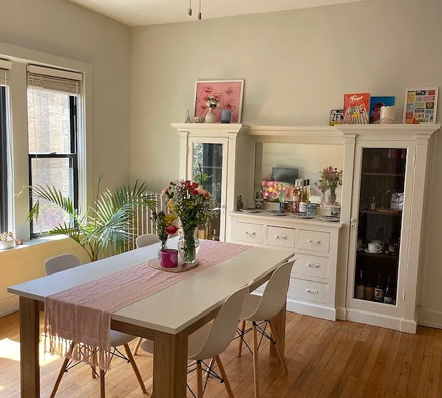 DINING ROOM WITH SOUTH FACING WINDOWS AND ORIGINAL BUILT-IN CABINET