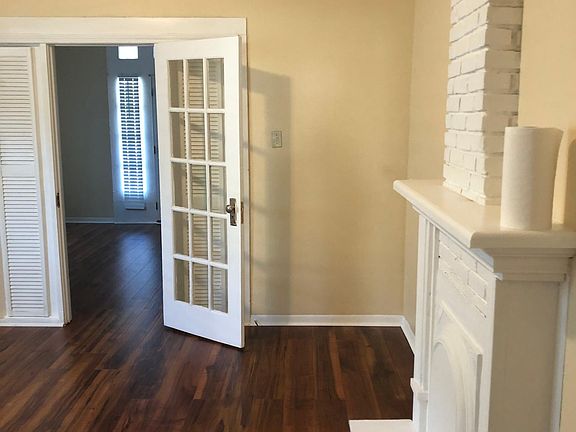 Bedroom with double closet.French door and mantle.