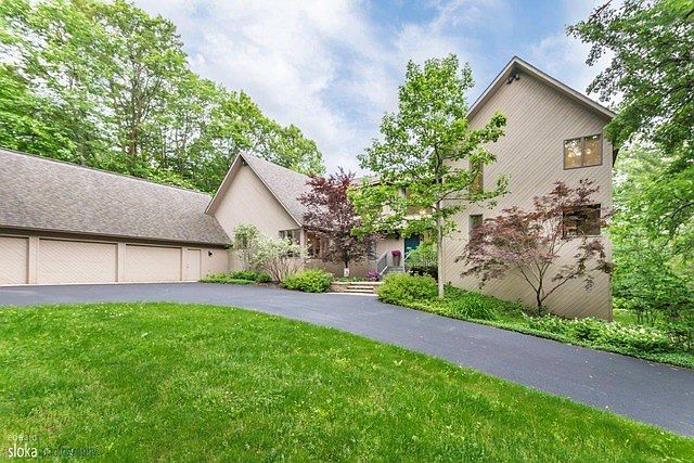 HOME IS NESTLED ON 4.15 ACRES OF NATURAL BEAUTY