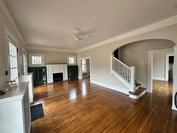 Sun filled front welcoming room, featuring 3 sets of original French doors, original built ins, gas fireplace. Private room to the right for seeing clients