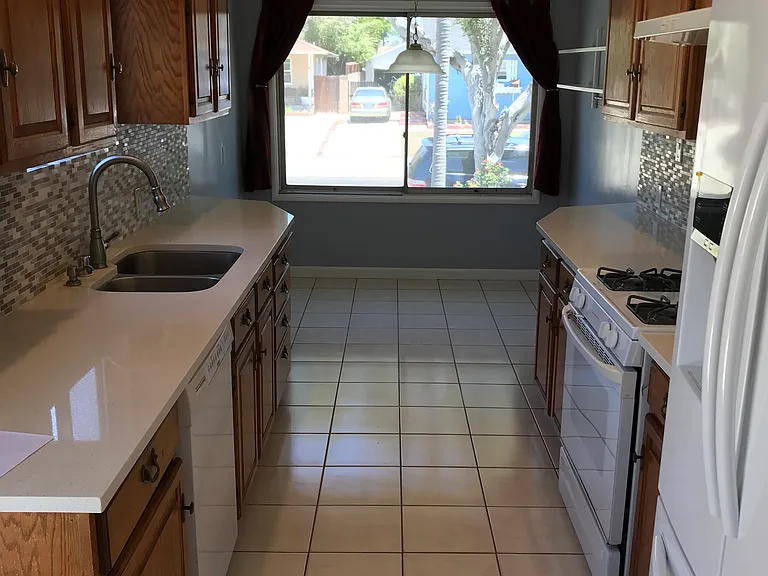 Kitchen with bright breakfast nook, recessed lighting, newer quartz countertops, and range, dishwasher, and refrigerator replaced within the last two years.