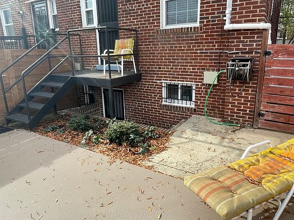 view of English basement entrance to studio from backyard patio