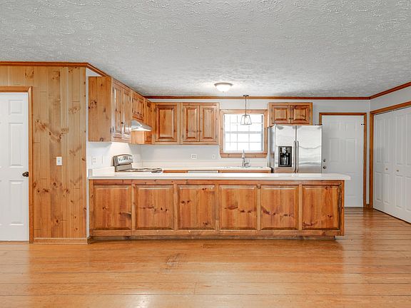 Kitchen with laundry closet, pantry, and door to back deck
