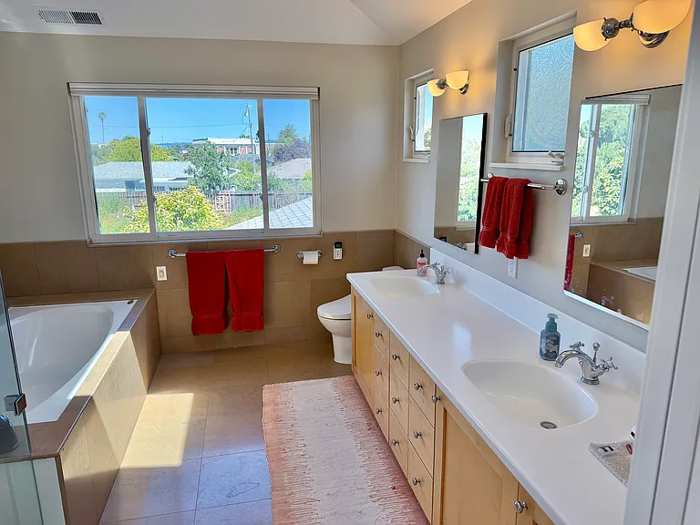 Master bath with spacious countertops, 2 sinks, Jacuzzi tub, shower, and radiant heated floors.