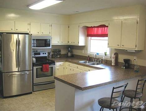 Kitchen offers breakfast bar, hard surface counter tops & very nice appliances...Refrigerator conveys!!