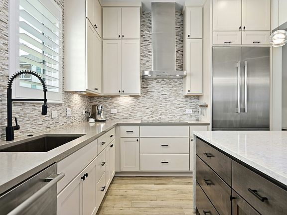 Induction cook top & custom built-in Thermador refrigerator.