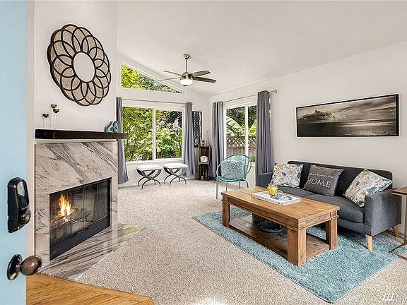 Vaulted ceilings and a beautiful custom stone fireplace welcomes you into this living room.