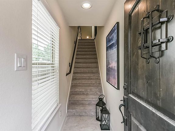 Beautiful solid wood door with iron accents welcomes your guests upon arrival