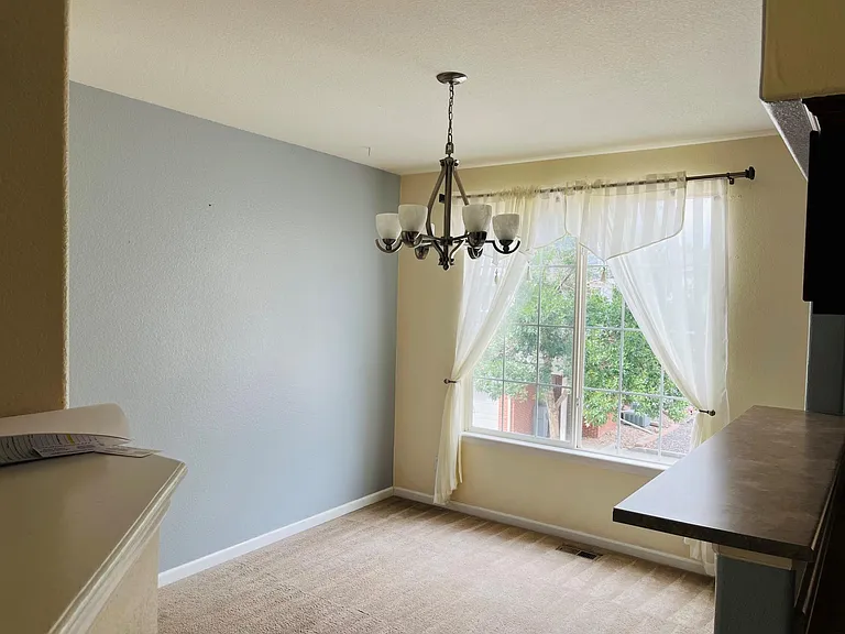 Dining room has large windows and a fireplace that is adjoining the family room .