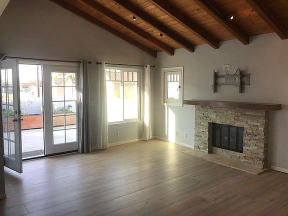 Bright, vaulted living room leading with new French doors leading to an upstairs deck