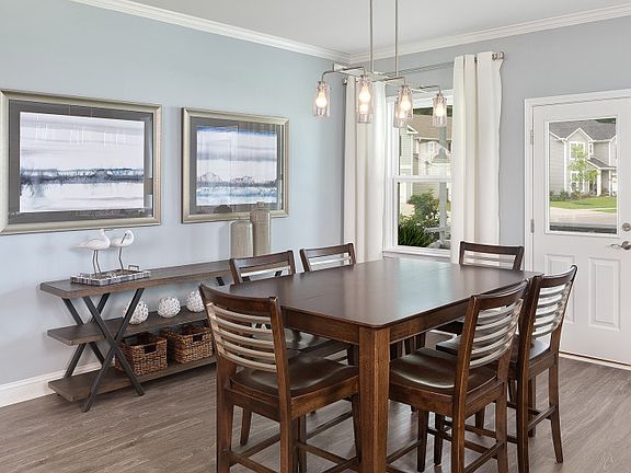 Enjoy meals in the Cafe area that opens to the Kitchen and Gathering Room. - Model Representation