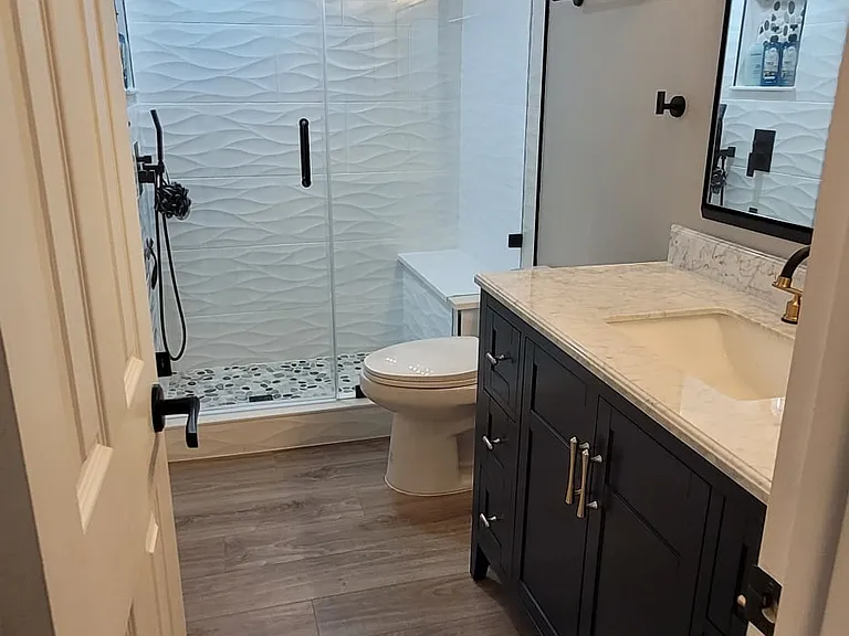 Main bathroom with walk-in shower, new vanity, new toilet with slow close lid and new flooring