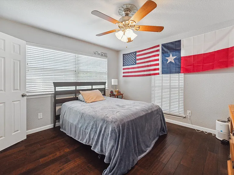 Spacious second bedroom featuring abundant natural light and a generous walk-in closet.