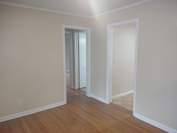 Another shot of the dining area with the kitchen and hallway off of it