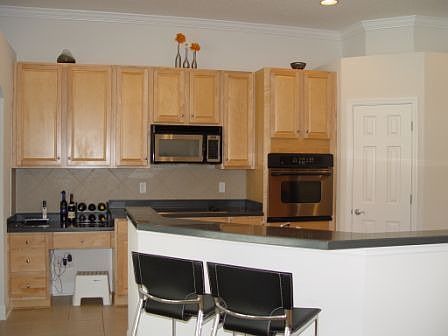 Kitchen with stainless steel appliances and Corian countertops