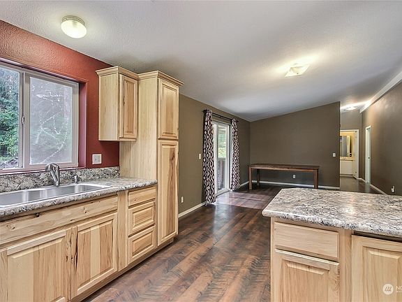 View from kitchen to dining room, you will love the ample cupboard and counter space. Dining table stays with home, patio doors off dining lead to your huge deck! >