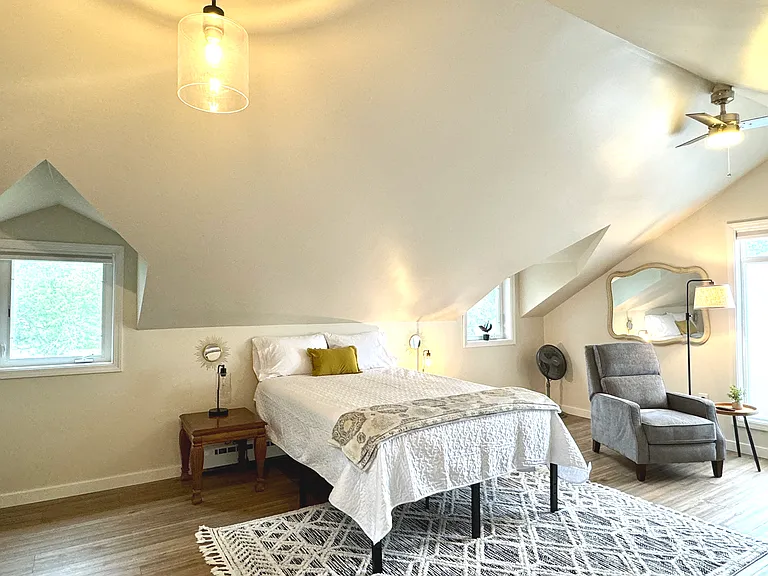 The spacious upstairs bedroom /space has a Queen bed and blackout blinds