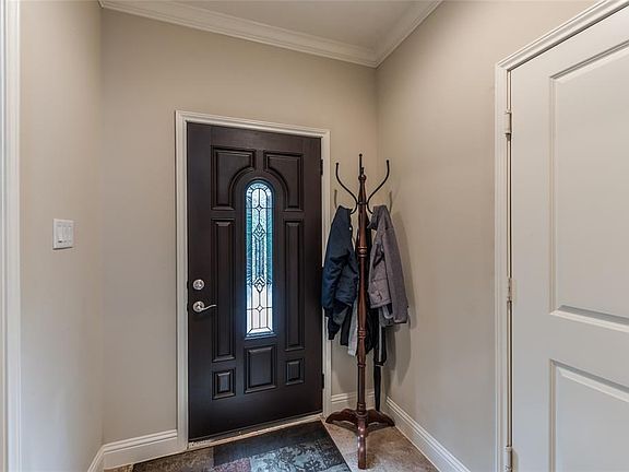 The foyer opens to the wide stairway and the 1st floor bedroom.